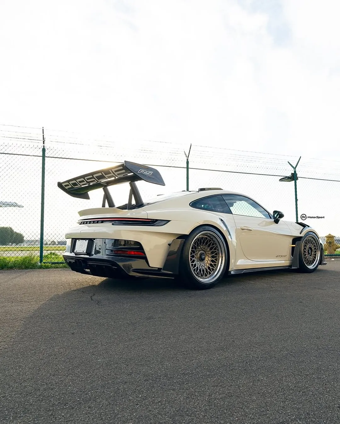 Porsche 992 GT3RS wrapped in Inozetek Boneyard White film. View 2