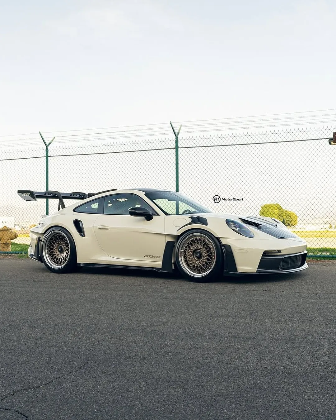 Porsche 992 GT3RS wrapped in Inozetek Boneyard White film. View 1